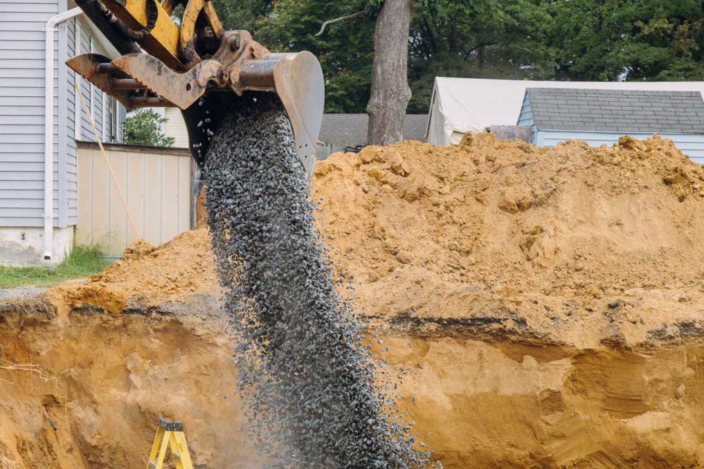 Industrial excavator for foundation building construction site bucket details dirt gravel all around